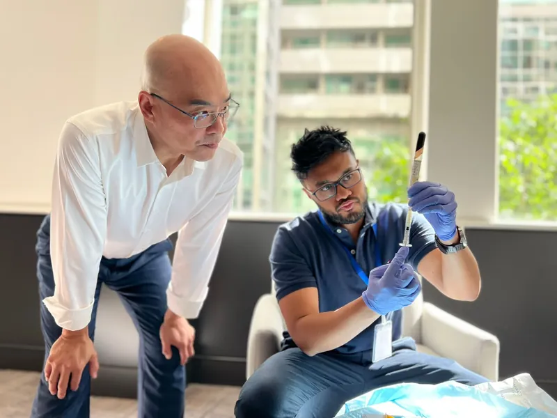Dr Rakib Uddin teaching injectable anatomy to another doctor