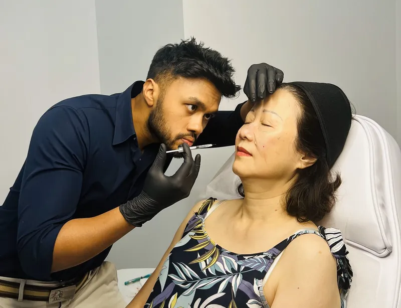 Dr Rakib Uddin assessing the under-eye area before treatment